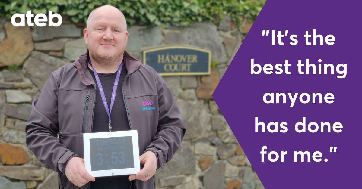 Staff member holding dementia clock